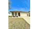 Charming single-story home featuring a well-maintained lawn, covered porch, and attached two-car garage at 1056 Naes Ln, Lake Wales, FL 33853
