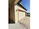 Attached two-car garage with convenient access and a well-kept exterior at 1056 Naes Ln, Lake Wales, FL 33853