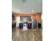 Cozy kitchen featuring stainless steel appliances and dark wood cabinets on an orange accent wall at 1056 Naes Ln, Lake Wales, FL 33853