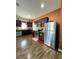 Well-equipped kitchen with stainless steel appliances, dark cabinets, and a convenient layout at 1056 Naes Ln, Lake Wales, FL 33853