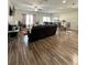 Open-concept living area with hardwood floors, a view of dining area, and a large sectional sofa at 1056 Naes Ln, Lake Wales, FL 33853