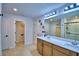 Bright bathroom featuring double sink vanity, large mirror, and glass shower at 1091 Sugarwood St, Davenport, FL 33837