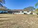Expansive backyard featuring a screened-in porch, a patio with a table set, and a hot tub at 11 Sun Air Blvd E, Haines City, FL 33844