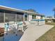 A backyard featuring a patio table with four chairs and a hot tub on a concrete pad at 11 Sun Air Blvd E, Haines City, FL 33844