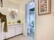 Clean bathroom features a white vanity, mirror, and walk-in shower at 11 Sun Air Blvd E, Haines City, FL 33844