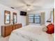 Bright bedroom features a ceiling fan, large window, and wood dresser at 11 Sun Air Blvd E, Haines City, FL 33844