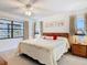 Comfortable bedroom with ceiling fan, large window, and side tables with lamps at 11 Sun Air Blvd E, Haines City, FL 33844