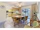 Open dining area with tile flooring, adjoining kitchen, and seamless transition to outdoor spaces at 11 Sun Air Blvd E, Haines City, FL 33844