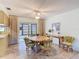 Dining area with tile floors, ceiling fan, and sliding glass doors to the lanai at 11 Sun Air Blvd E, Haines City, FL 33844