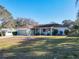 Charming single-story home with a well-manicured lawn, complemented by mature landscaping and a neatly paved driveway at 11 Sun Air Blvd E, Haines City, FL 33844