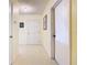 Bright hallway with neutral tile flooring, leading to multiple rooms in the house at 11 Sun Air Blvd E, Haines City, FL 33844