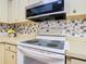Kitchen featuring modern microwave and tile backsplash, with ample counter space for cooking at 11 Sun Air Blvd E, Haines City, FL 33844
