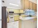 Functional kitchen with white appliances, tile backsplash, and ample cabinet space at 11 Sun Air Blvd E, Haines City, FL 33844