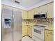 Efficient kitchen with stainless steel refrigerator, microwave, and plenty of cabinet storage at 11 Sun Air Blvd E, Haines City, FL 33844