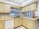 Bright kitchen features tile backsplash, window view, and ample counter space at 11 Sun Air Blvd E, Haines City, FL 33844