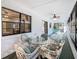 Covered lanai features a glass table with outdoor seating and views of the yard at 11 Sun Air Blvd E, Haines City, FL 33844
