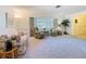 Bright living room showcasing a large bay window, plush seating, and neutral decor at 11 Sun Air Blvd E, Haines City, FL 33844