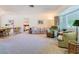 Cozy living room with neutral carpet, large windows, and comfortable seating arrangement at 11 Sun Air Blvd E, Haines City, FL 33844