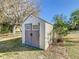 A quaint outdoor shed with gray doors and a John Deere Road sign at 11 Sun Air Blvd E, Haines City, FL 33844