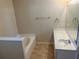 This bathroom includes a built-in tub and single sink vanity at 1106 Partridge Way, Kissimmee, FL 34759