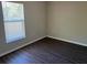 Inviting bedroom with wood-look floors, neutral walls, and a large window creating a serene and peaceful retreat at 1106 Partridge Way, Kissimmee, FL 34759
