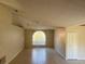 Bright living room with natural light streaming through a large window, complemented by tiled floors and neutral walls at 1106 Partridge Way, Kissimmee, FL 34759