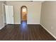 Spacious living room featuring modern wood-look floors and arched entryways, creating a bright and inviting space at 1106 Partridge Way, Kissimmee, FL 34759