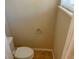 A toilet in the bathroom, with a window letting in natural light at 1106 Partridge Way, Kissimmee, FL 34759