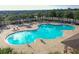 An aerial view of the large, uniquely shaped community pool and surrounding lounge area at 1108 Zion Dr, Haines City, FL 33844