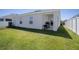 Backyard showing the rear patio, a grill, and a spacious lawn, perfect for outdoor enjoyment at 1108 Zion Dr, Haines City, FL 33844