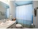 Clean bathroom featuring a single sink, a toilet, and a shower with blue accents at 1108 Zion Dr, Haines City, FL 33844