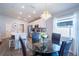 Open concept dining area with a glass-top table and chandelier next to the kitchen at 1108 Zion Dr, Haines City, FL 33844