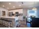 Open kitchen with stainless steel appliances, counter seating, and adjacent dining area at 1108 Zion Dr, Haines City, FL 33844