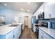Bright kitchen featuring stainless steel appliances, granite countertops, and wood flooring at 1108 Zion Dr, Haines City, FL 33844
