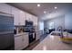 Modern kitchen featuring stainless steel appliances, white cabinets, and granite countertops at 1108 Zion Dr, Haines City, FL 33844