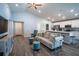 Open-concept living room featuring modern decor, wood flooring, and seamlessly connected to the kitchen at 1108 Zion Dr, Haines City, FL 33844