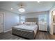 Relaxing main bedroom with a tufted headboard bed, neutral tones, and bright natural lighting at 1108 Zion Dr, Haines City, FL 33844