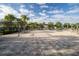 Paver pool deck with multiple lounge chairs, covered areas, and beautiful landscaping at 1108 Zion Dr, Haines City, FL 33844