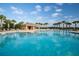 Community swimming pool with palm trees and ample seating plus a covered lounge area at 1108 Zion Dr, Haines City, FL 33844