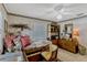 Inviting bedroom featuring a comfy daybed, large window, and classic wooden dresser at 1116 Cypress W Pt, Winter Haven, FL 33884