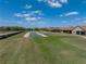 Aerial shot of a neighborhood with pond, showcasing well-maintained lawns and attractive home exteriors at 1124 Sawgrass Dr, Winter Haven, FL 33884