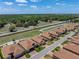 Beautiful home in a peaceful community with manicured lawns, set against a backdrop of trees and a nearby pond at 1124 Sawgrass Dr, Winter Haven, FL 33884
