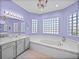 Bathroom featuring a soaking tub, updated light fixtures, and a modern vanity at 1124 Sawgrass Dr, Winter Haven, FL 33884