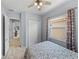 Bedroom features closet, large window, ceiling fan and a calming color scheme at 1124 Sawgrass Dr, Winter Haven, FL 33884
