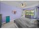 Bedroom features a ceiling fan, large window, and a relaxing color scheme at 1124 Sawgrass Dr, Winter Haven, FL 33884