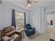 Bedroom with pale blue walls, neutral carpet, ceiling fan, window, and closet at 1124 Sawgrass Dr, Winter Haven, FL 33884