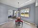 Sunlit dining area featuring tile floors, a round table, and views into adjacent rooms at 1124 Sawgrass Dr, Winter Haven, FL 33884