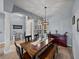 Bright dining area featuring a rustic table, stylish lighting, and neutral walls at 1124 Sawgrass Dr, Winter Haven, FL 33884