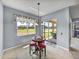 Charming dining area with a round table set and a view of the outdoor patio and greenery at 1124 Sawgrass Dr, Winter Haven, FL 33884
