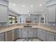 Kitchen featuring a granite countertop, stainless steel appliances, and views into the living room at 1124 Sawgrass Dr, Winter Haven, FL 33884